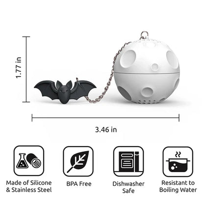 White tea ball infuser with black bat-shaped tea bag and dimensions on a white background